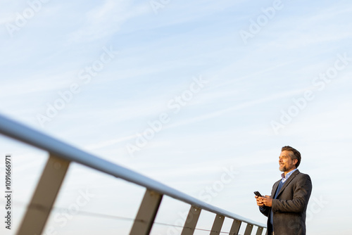 A businessman checks his sm...