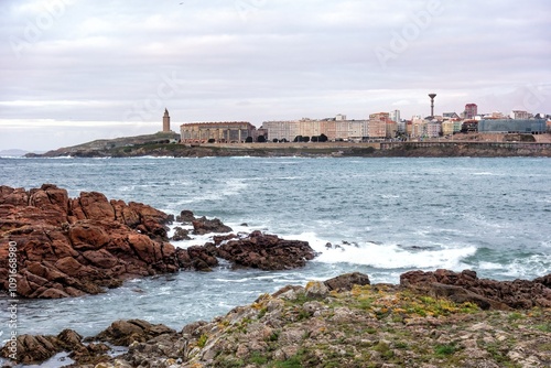 Riazor beach bay in the Spanish city of A Coruña and the Hercules tower lighthouse in the background