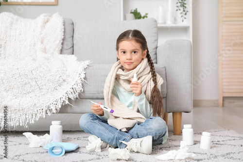 Sick little girl with therm...