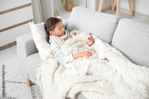 Sick little girl with therm...