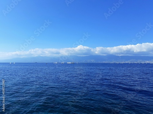 Lo Stretto di Messina visto da Reggio Calabria. Piccola regata velica in corso. photo