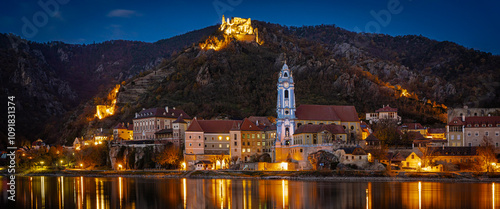 Dürnstein panorama at night with abbey and ruins - view from Rossatz to Dürnstein on the opposite bank of the Danube in the World Heritage Site Wachau Austria