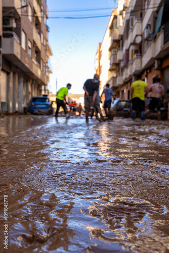 Photo shows the aftermath of flood in Alfafar, Valencia, Spain. Captured are damaged homes, roads, and the efforts of residents and volunteers to clean and rebuild. photo