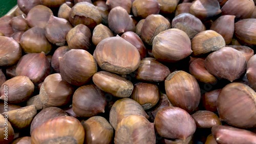 Chestnuts seen from above. Tracking shot on chestnuts displayed at the grocery store