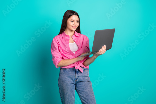 Photo portrait of pretty teen girl hold netbook wear trendy pink outfit isolated on aquamarine color background photo