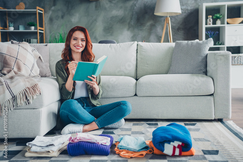 Photo of adorable sweet lady wear khaki shirt packing clothes writing checklist indoors room home house photo