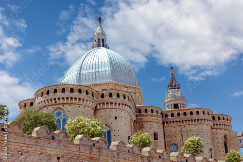 The stunning architecture of the Basilica of the Holy House in Loreto under a vibrant blue sky. Loreto, Marche, Italy