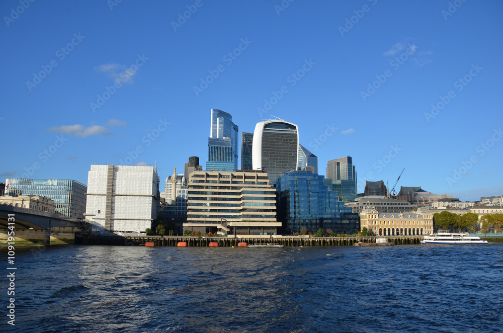 Naklejka premium London, England, United Kingdom - October 2024: Panoramic view of Bank, London's leading financial district with blue sky and clouds autumn or fall