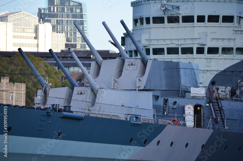 London, England, United Kingdom - October 2024:HMS Belfast moored in front of Tower Bridge on the River Thames photo