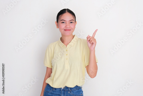 A woman smiling confident with one of her hand pointing beside her photo