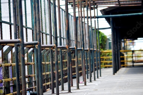 Construction of yellow safety iron fence in multi storey vehicle parking area photo