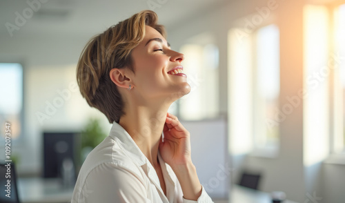 beautiful woman massages her neck with pleasure in the office Free Download beautiful woman massages her neck with pleasure in the office - GFXLoad
