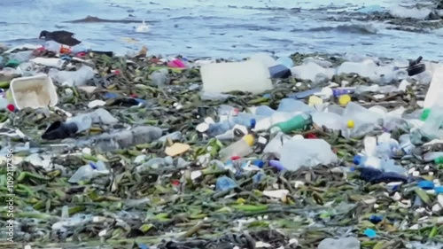 The ocean waves carry a significant amount of plastic waste, highlighting the extent of marine pollution. Striking footage for environmental awareness and sustainability campaigns.