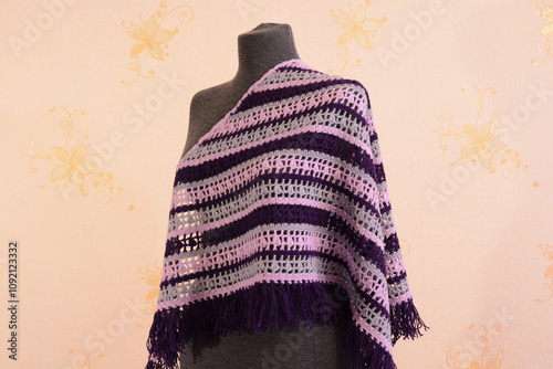Shawl crocheted from pink, purple and gray yarn on a mannequin