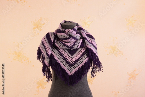 Shawl crocheted from pink, purple and gray yarn on a mannequin