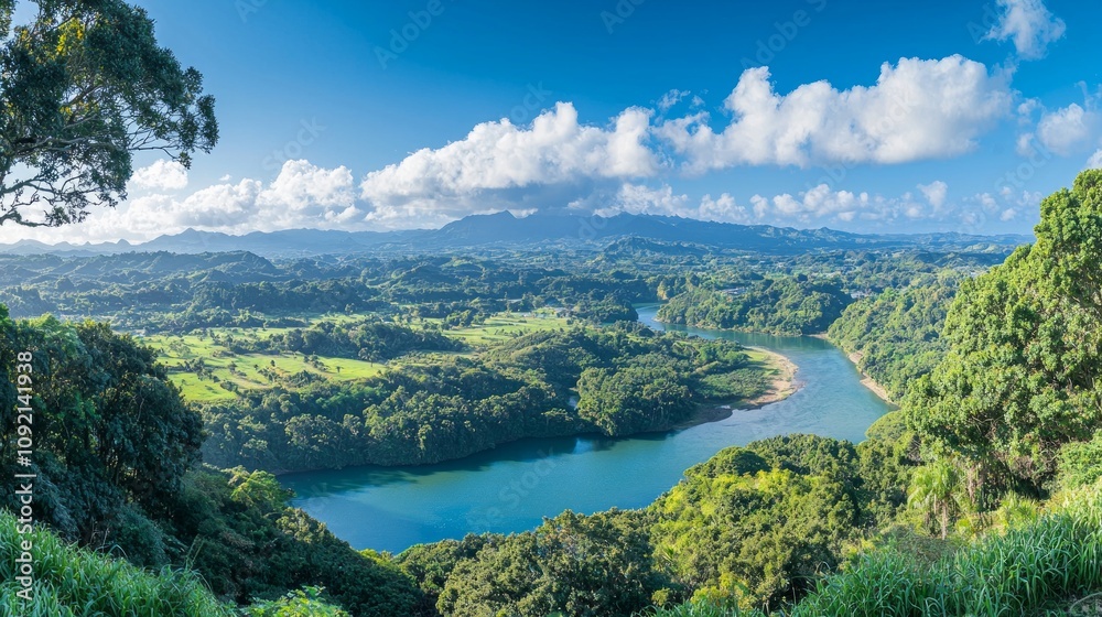 Obraz premium Lush green landscape with a winding river under a clear blue sky.