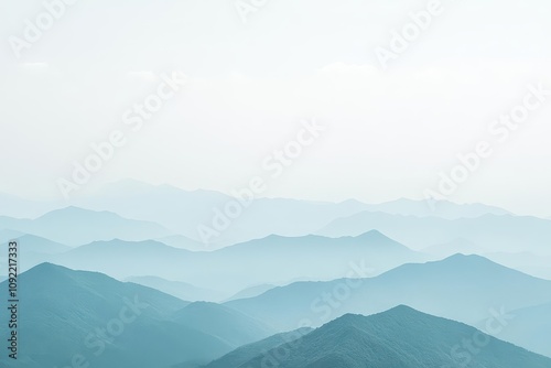 Serene mountain landscape with soft blue hues.
