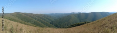 Vast rolling hills under a clear blue sky.