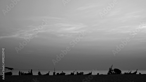 Silhouette of boats lined up on the beach , black & white