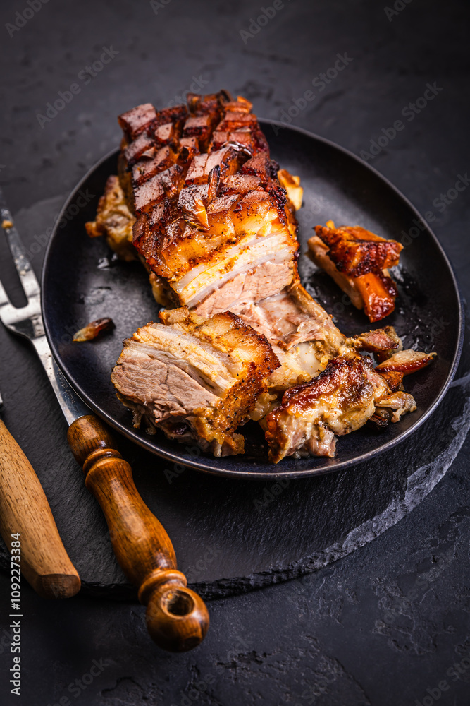 Crispy baked pork belly on black background Crispy baked pork belly on black background