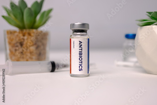 A liquid antibiotic in a vial standing on a white clinic table. medical concept