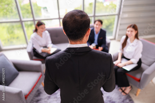 Asian Senior Manager Leading Team Discussion in a Corporate Office, Showcasing Leadership, Teamwork, and Strategy Development During a Professional Business Meeting with Engaged Employees