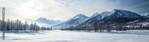 Snowy mountain landscape with serene river and trees under a cloudy sky.