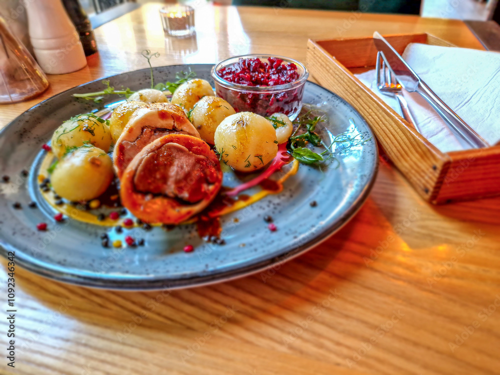 Roulade with dumplings and fried beetroots.
