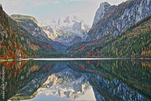 Obraz na płótnie Colorful Autumn scenery and reflections on The Vorderer Gosausee (lower lake), Salzkammergut, Styria, Austria, Europe, with the Dachstein mountains in the background w salonie