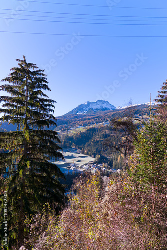 Scenic aerial view of alpine landscape with idyllic Swiss mountain village of Tiefencastel at Albula Valley on a sunny autumn day. Photo taken November 15th, 2024, Tiefencastel, Switzerland. photo