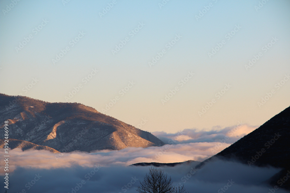 Obraz premium sunset over the mountains, Mountains in fog, mountain valley in fog and clouds, Low clouds, Foggy morning in the mountains