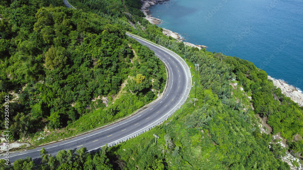 Aerial view serpentine road and forest with sea. Aerial view serpentine road and forest with sea.