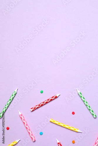 Multi-colored holiday candles on color background, flat lay. Birthday concept  photo