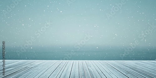 A serene winter scene featuring a wooden deck covered in snow, overlooking a tranquil blue ocean under soft snowfall