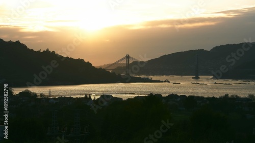 Ría of Vigo at the sunset with the sun and Rande's bridge in the background, Galicia Spain