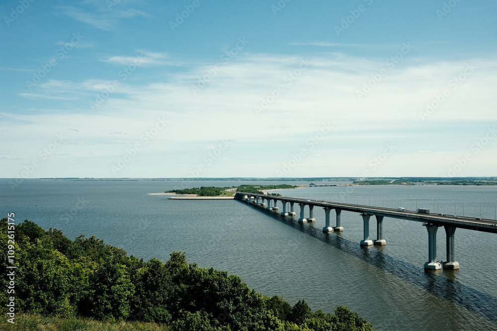 Automobile bridge over the Kama River. View of the Kama from the Sorochi Mountains in Tatarstan. Beautiful summer landscape. Automobile bridge over the Kama River. View of the Kama from the Sorochi Mountains in Tatarstan. Beautiful summer landscape.