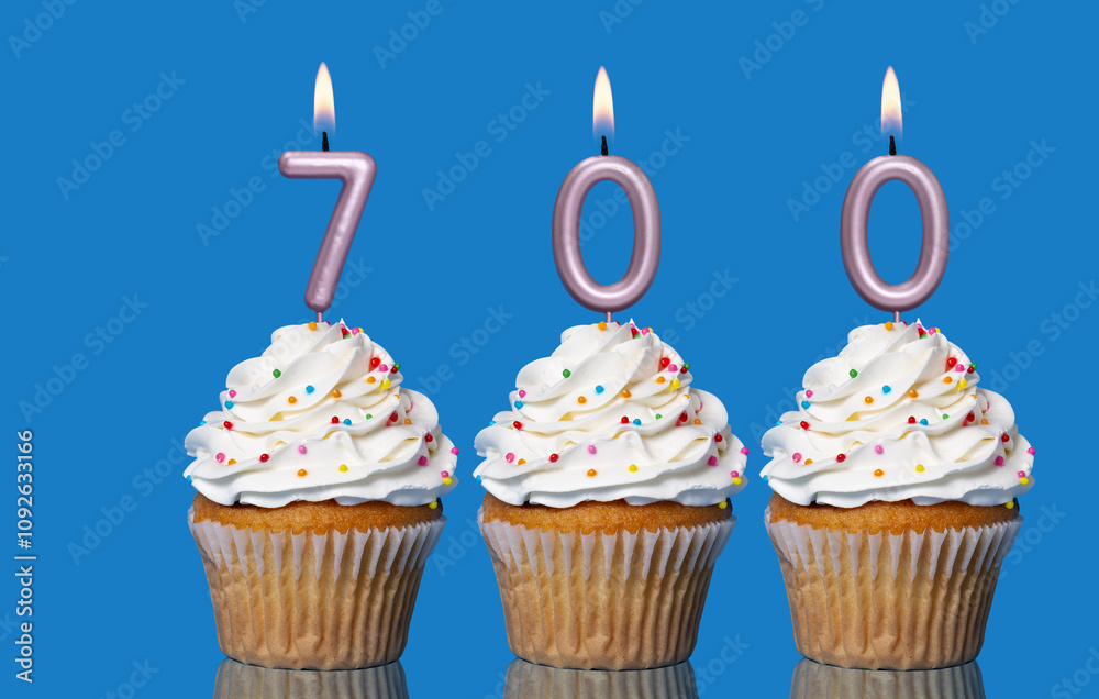 Birthday Cupcakes With Candles Lit Forming The Number 700