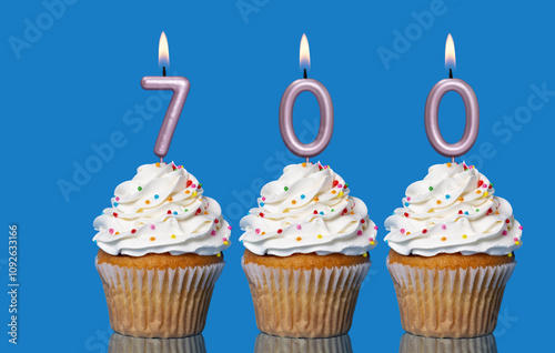 Birthday Cupcakes With Candles Lit Forming The Number 700