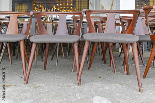 Many Brown Wood Chairs With Textile Seats in Restaurant Storage photo