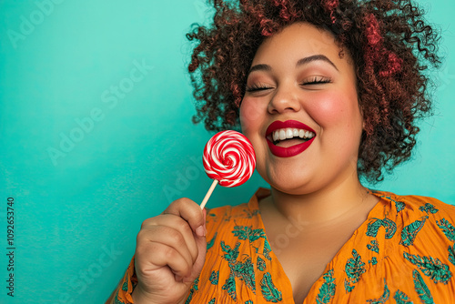 Plus-size girl enjoying a lollipop in a playful pose photo