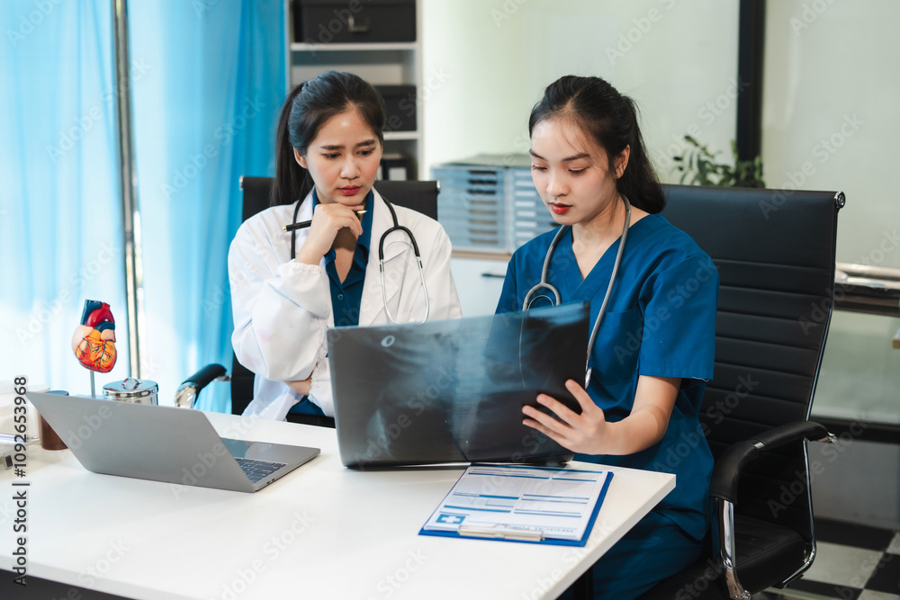 Medical team working on digital tablet healthcare doctor technology tablet using x-ray film analyzed the results of medical reports Medical team working on digital tablet healthcare doctor technology tablet using x-ray film analyzed the results of medical reports