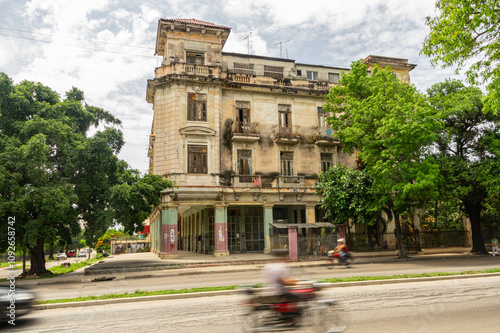 Abandoned historic building with passing traffic motion blur photo