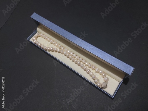 pearl necklace in blue packgage isolated
