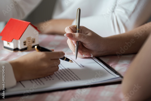 Konstfotografi Signing Real Estate Contract with Model House on Table - Close-up of Hands and P