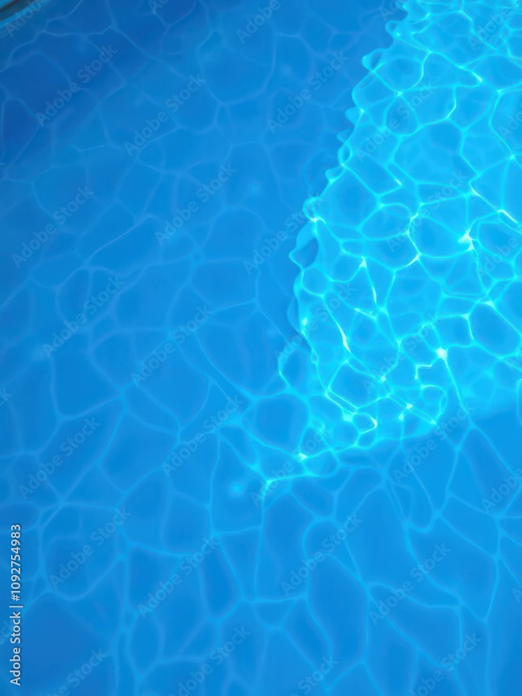 Blue water in a swimming pool with rippling waves, pure, liquid Blue water in a swimming pool with rippling waves, pure, liquid