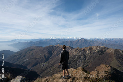 Young man look at a view of the swiss and italian alps