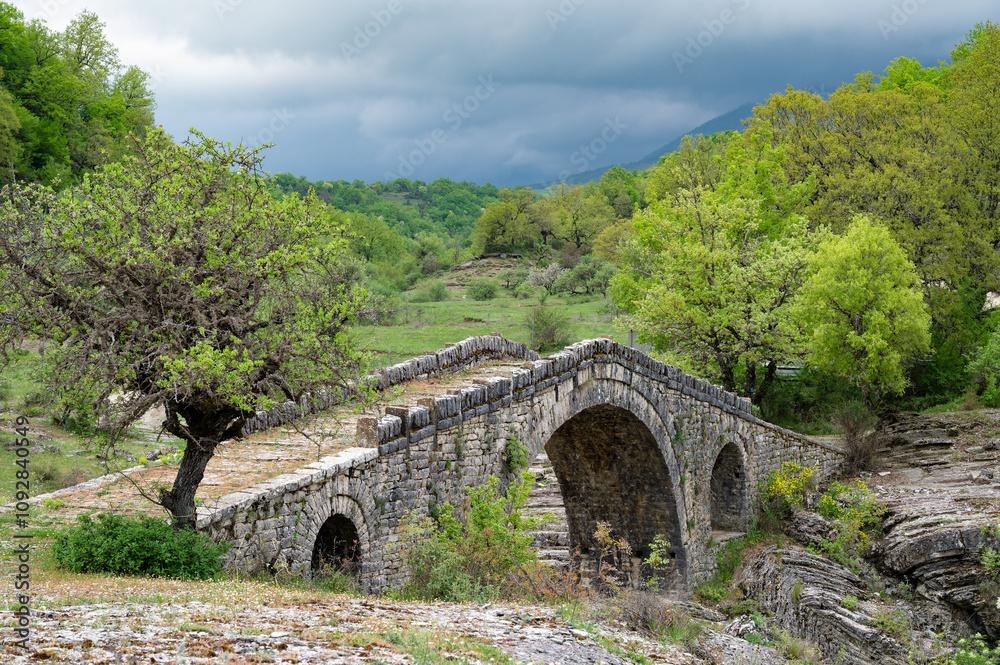 View of the traditional stone Bridge of Greci in Epirus, Greece in Spring. View of the traditional stone Bridge of Greci in Epirus, Greece in Spring.