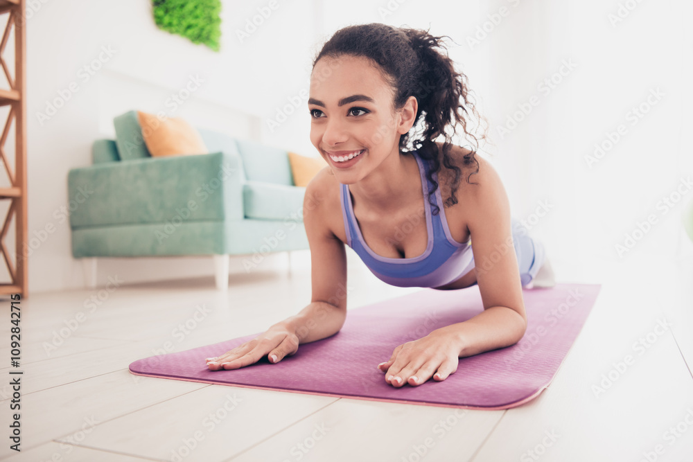 Young woman practicing yoga indoors in a modern apartment, wearing stylish activewear and enjoying fitness in natural daylight. Young woman practicing yoga indoors in a modern apartment, wearing stylish activewear and enjoying fitness in natural daylight.