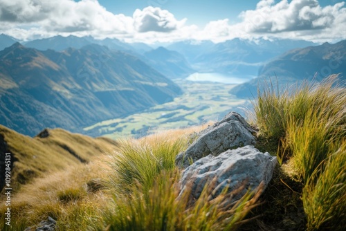 A stunning mountain landscape shot with a 21mm lens, focusing on rocks and grass in the foreground. photo