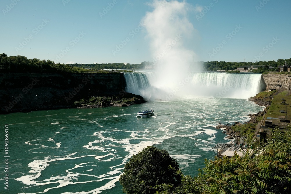 Scenic view of Niagara Falls with tour boat. Scenic view of Niagara Falls with tour boat.